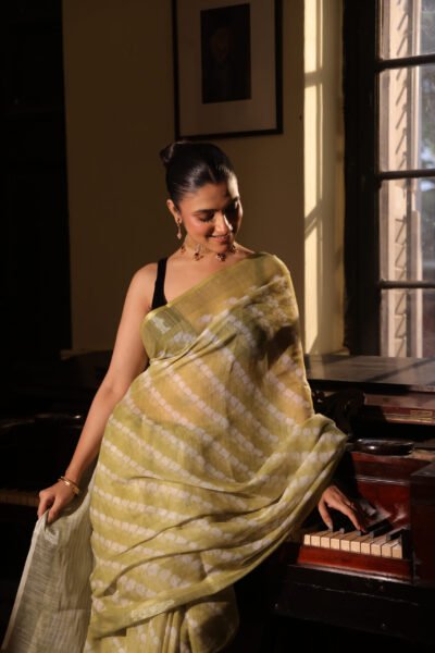 Lime green linen saree with white ajrakh print with tassels