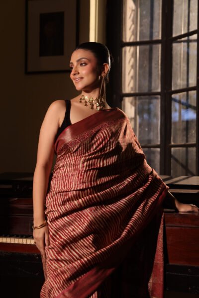 Maroon ajrakh maheshwari silk saree with brocade border & blouse with tassels